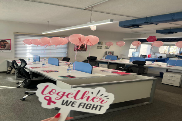 Whitney leaning against a railing on a downtown street